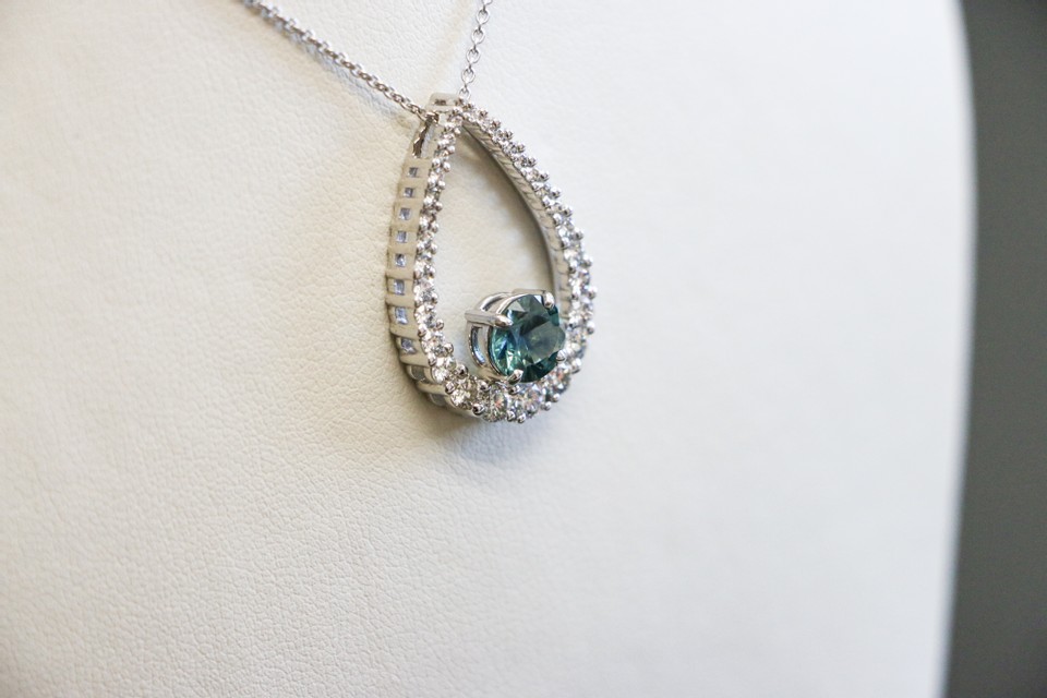 Teardrop diamond pendant with a Montana sapphire